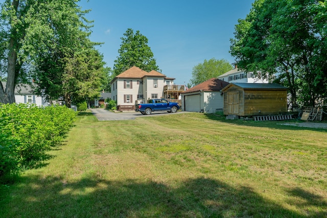 11 Gertrude Ave, Biddeford, ME 04005 - view of green lawn with a storage shed and asphalt driveway