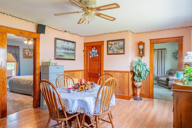 11 Gertrude Ave, Biddeford, ME 04005 - dining area featuring a ceiling fan, light wood-type flooring, a wainscoted wall, and wooden walls