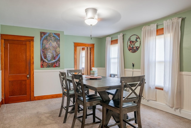 11 Gertrude Ave, Biddeford, ME 04005 - dining room with a wainscoted wall, light colored carpet, ceiling fan, and a baseboard heating unit