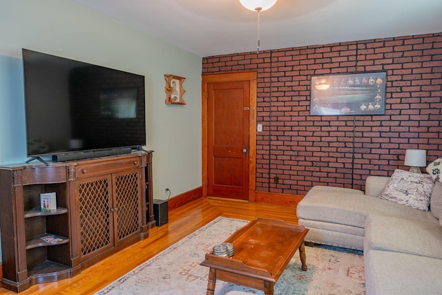 11 Gertrude Ave, Biddeford, ME 04005 - living room featuring brick wall, wood finished floors, and an accent wall