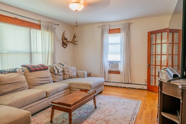 11 Gertrude Ave, Biddeford, ME 04005 - living room with baseboard heating, cooling unit, and light wood-style floors
