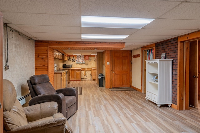 11 Gertrude Ave, Biddeford, ME 04005 - living area featuring a drop ceiling, light wood-style floors, and a baseboard radiator