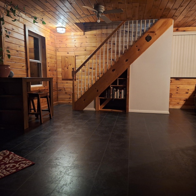 71 Mountain View Dr, Hartford, ME 04220 - unfurnished living room featuring wooden walls, stairs, wood ceiling, and a ceiling fan
