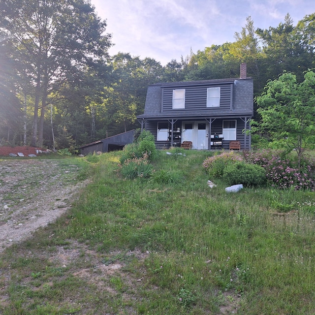 71 Mountain View Dr, Hartford, ME 04220 - back of house featuring a chimney and covered porch