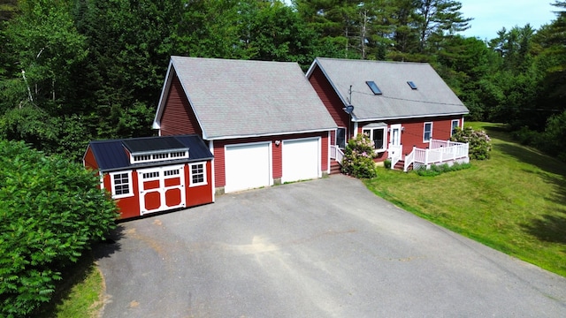 27 Hodgdon Rd, Levant, ME 04456 - view of front facade with driveway, an attached garage, a front lawn, and an outdoor structure