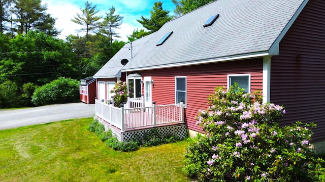 27 Hodgdon Rd, Levant, ME 04456 - back of property featuring a wooden deck, a lawn, and a shingled roof