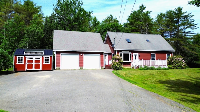 27 Hodgdon Rd, Levant, ME 04456 - cape cod-style house with a garage, asphalt driveway, a front lawn, a shed, and a wooden deck