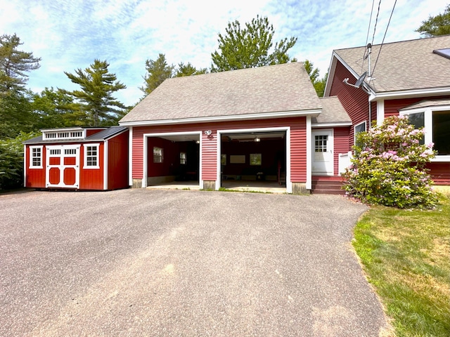 27 Hodgdon Rd, Levant, ME 04456 - view of front facade featuring a storage unit, driveway, and a shingled roof