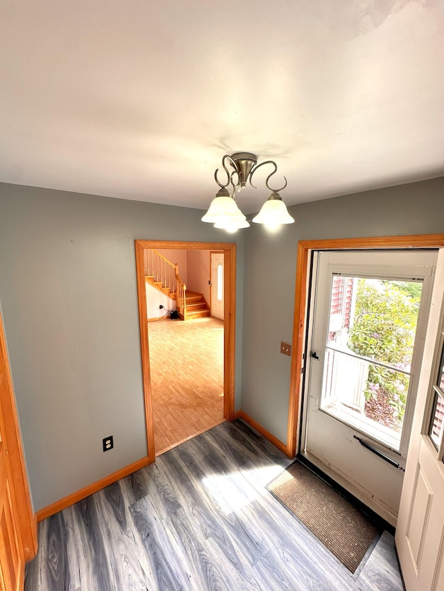 27 Hodgdon Rd, Levant, ME 04456 - spare room with stairs, wood finished floors, and a chandelier