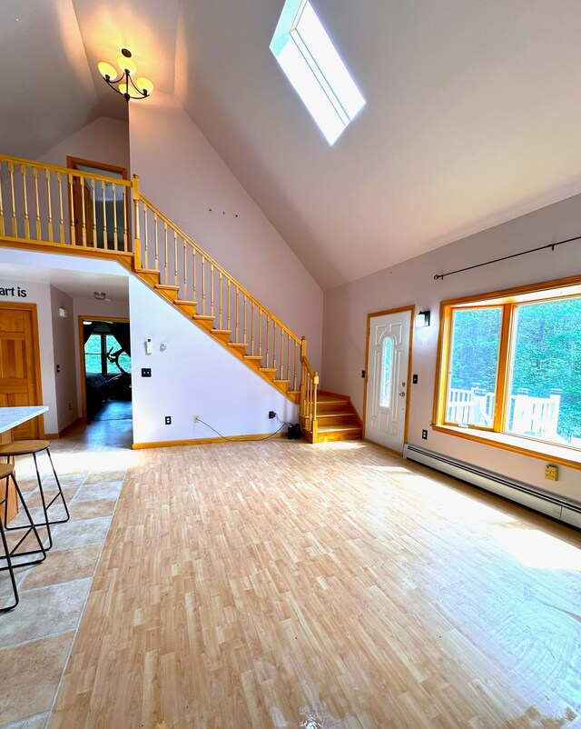 27 Hodgdon Rd, Levant, ME 04456 - unfurnished living room with stairs, high vaulted ceiling, and light wood-style flooring