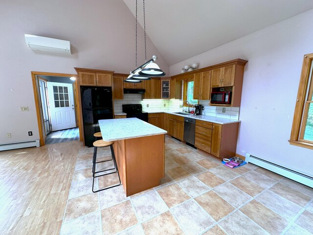 27 Hodgdon Rd, Levant, ME 04456 - kitchen featuring black appliances, a wall mounted air conditioner, brown cabinetry, a center island, and backsplash