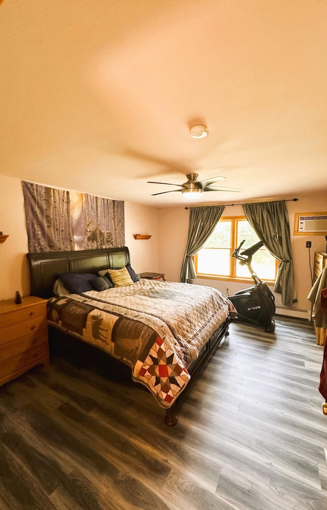 27 Hodgdon Rd, Levant, ME 04456 - bedroom featuring wood finished floors, a wall unit AC, and a ceiling fan