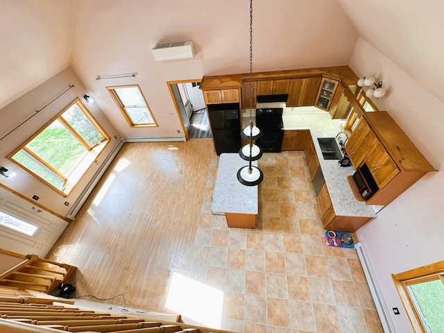 27 Hodgdon Rd, Levant, ME 04456 - unfurnished living room featuring a wall mounted AC and high vaulted ceiling