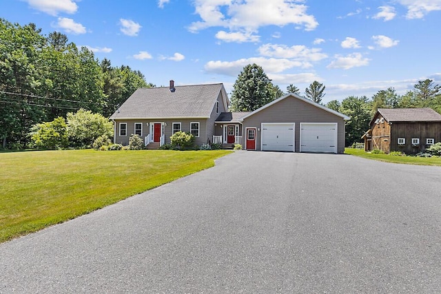 34 Cari Way, Sidney, ME 04330 - view of front of house with asphalt driveway, a garage, a front lawn, and a chimney