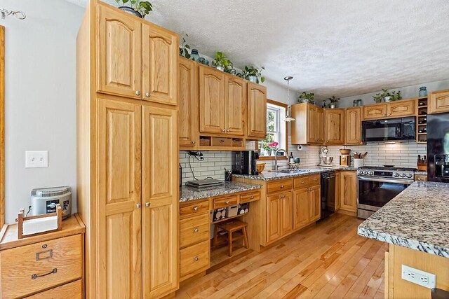 34 Cari Way, Sidney, ME 04330 - kitchen featuring black appliances, a textured ceiling, light wood-style flooring, decorative backsplash, and decorative light fixtures