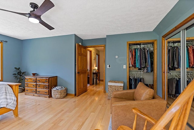 34 Cari Way, Sidney, ME 04330 - bedroom featuring a textured ceiling, light wood-style floors, and ceiling fan