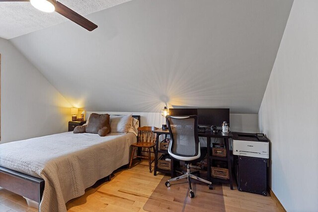 34 Cari Way, Sidney, ME 04330 - bedroom featuring vaulted ceiling, wood finished floors, and a textured ceiling