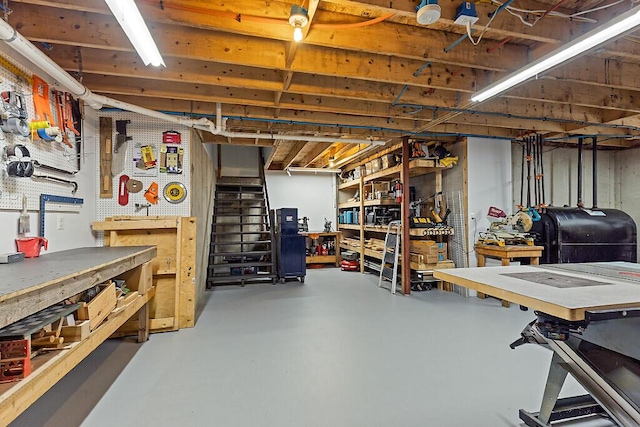 34 Cari Way, Sidney, ME 04330 - unfinished basement with a workshop area and oil tank
