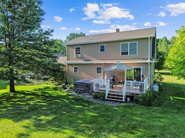 34 Cari Way, Sidney, ME 04330 - rear view of house with a hot tub, a deck, a lawn, and a chimney