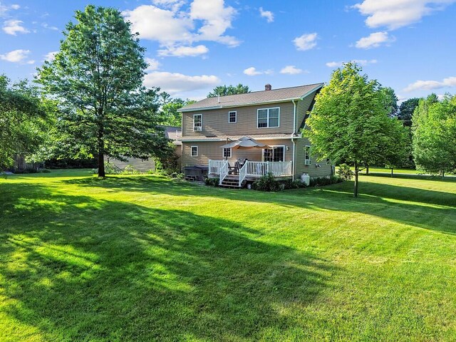 34 Cari Way, Sidney, ME 04330 - rear view of house featuring a yard, a chimney, and a wooden deck