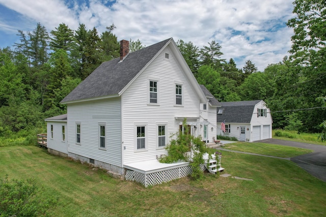 10 Jones Way, Sullivan, ME 04664 - view of side of property featuring an outdoor structure, a shingled roof, a chimney, and a yard