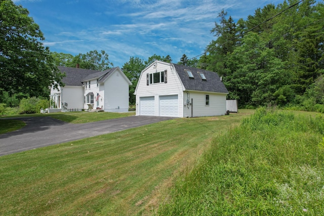 10 Jones Way, Sullivan, ME 04664 - view of front of house featuring asphalt driveway, an outbuilding, a front yard, and a gambrel roof