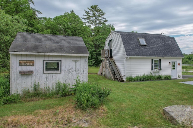 10 Jones Way, Sullivan, ME 04664 - view of side of home featuring stairway, a yard, a gambrel roof, and an outbuilding