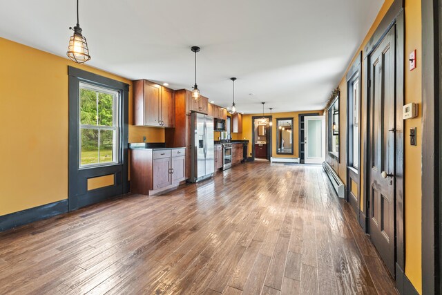 10 Jones Way, Sullivan, ME 04664 - kitchen featuring appliances with stainless steel finishes, dark wood-style flooring, baseboard heating, pendant lighting, and brown cabinetry