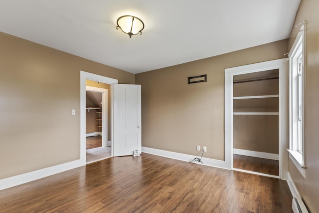 10 Jones Way, Sullivan, ME 04664 - unfurnished bedroom featuring wood finished floors, a baseboard heating unit, and a closet