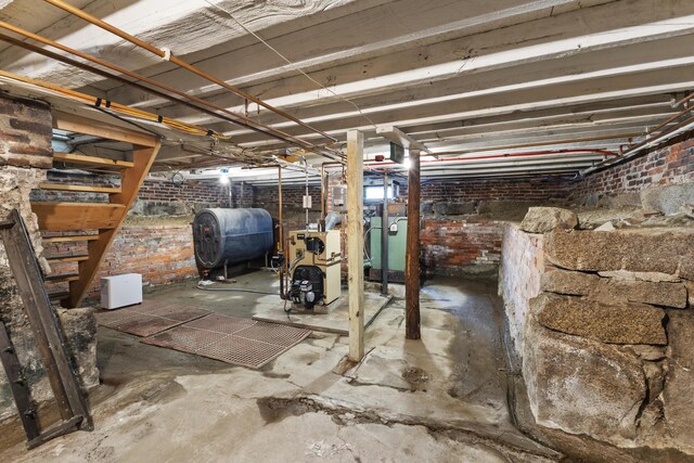 10 Jones Way, Sullivan, ME 04664 - unfinished below grade area with oil tank, a heating unit, and brick wall