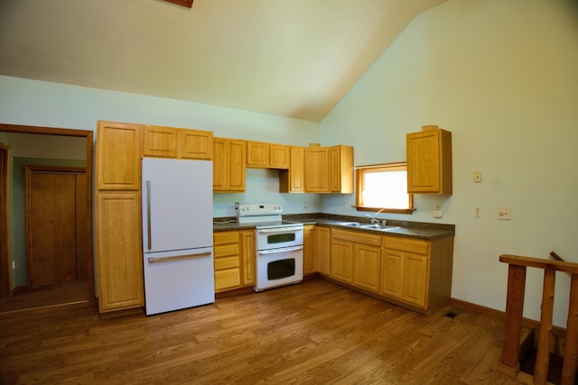 199 Middle Rd, Bradford, ME 04410 - kitchen featuring white appliances, dark countertops, high vaulted ceiling, and dark wood-type flooring