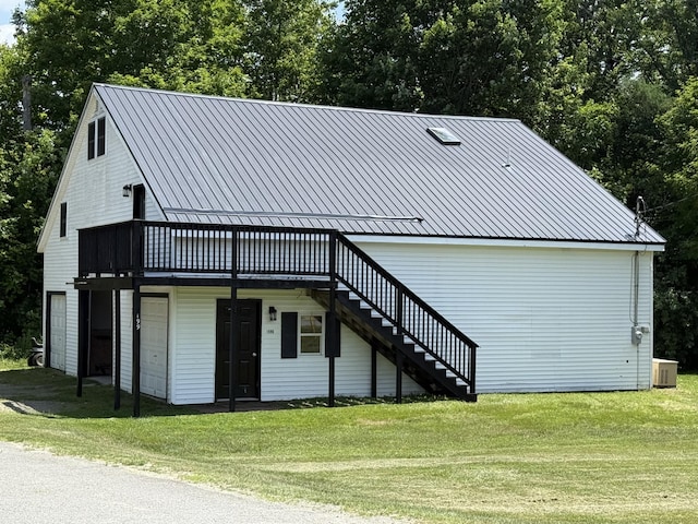 199 Middle Rd, Bradford, ME 04410 - view of front of house with stairway, a wooden deck, a front lawn, and a metal roof