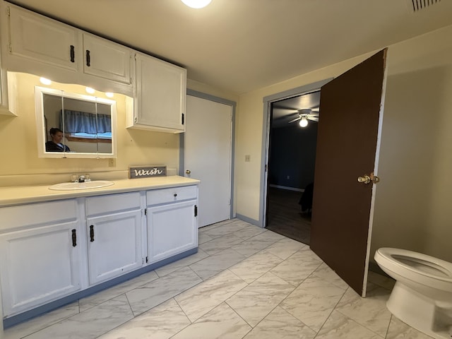 199 Middle Rd, Bradford, ME 04410 - kitchen with light marble finish floors, light countertops, white cabinets, and ceiling fan