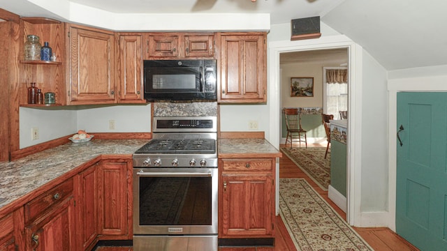 133 Hio Ridge Rd, Bridgton, ME 04009 - kitchen with stainless steel gas range, black microwave, light wood finished floors, and brown cabinets
