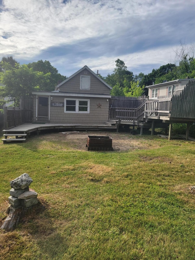 67 Stevens St, Lewiston, ME 04240 - back of property with a deck and a lawn