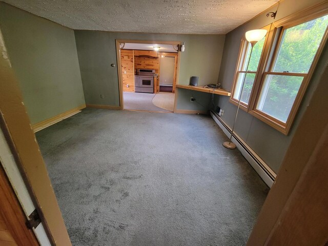 67 Stevens St, Lewiston, ME 04240 - carpeted empty room with a baseboard radiator and a textured ceiling