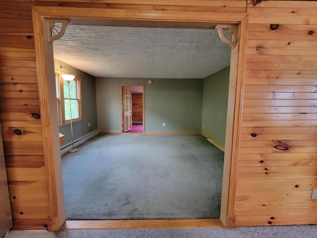 67 Stevens St, Lewiston, ME 04240 - empty room featuring a baseboard heating unit, carpet floors, and a textured ceiling