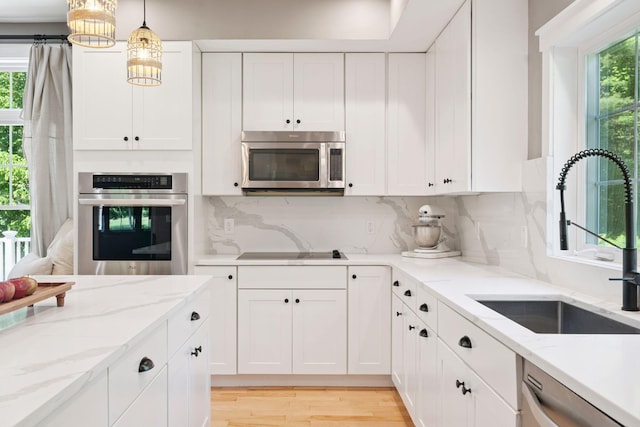 65 Wildbrook Ln, Eliot, ME 03903 - kitchen with appliances with stainless steel finishes, healthy amount of natural light, and white cabinets