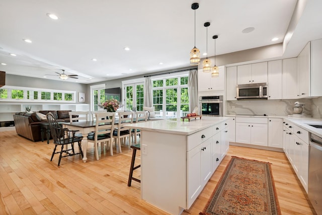 65 Wildbrook Ln, Eliot, ME 03903 - kitchen with appliances with stainless steel finishes, light wood-style flooring, plenty of natural light, and recessed lighting