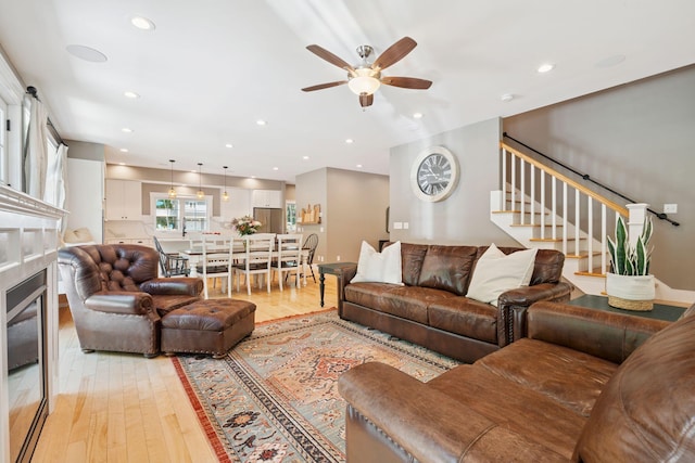 65 Wildbrook Ln, Eliot, ME 03903 - living area with ceiling fan, light wood-style floors, stairs, a glass covered fireplace, and recessed lighting