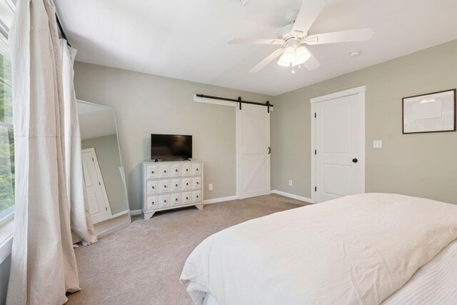 65 Wildbrook Ln, Eliot, ME 03903 - bedroom with carpet flooring, a barn door, and a ceiling fan