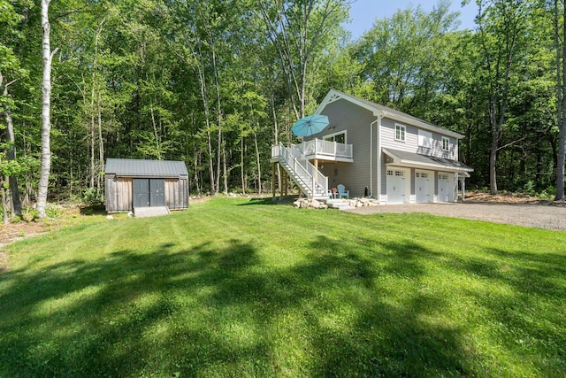 65 Wildbrook Ln, Eliot, ME 03903 - view of front of home with a storage shed, stairway, a garage, a wooden deck, and gravel driveway
