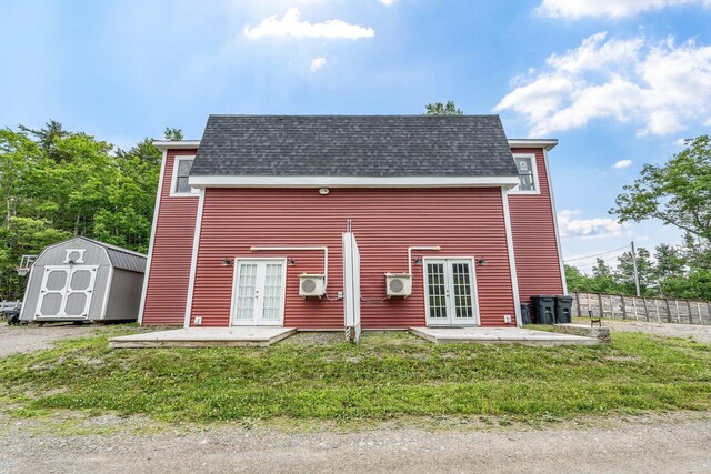 17 Applehead Way, Orrington, ME 04474 - back of property with french doors, a storage shed, a shingled roof, and a patio