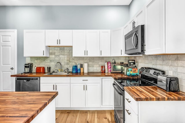 17 Applehead Way, Orrington, ME 04474 - kitchen featuring butcher block counters, black electric range, dishwashing machine, and white cabinets