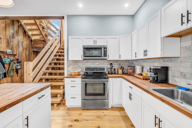 17 Applehead Way, Orrington, ME 04474 - kitchen featuring appliances with stainless steel finishes, butcher block counters, backsplash, white cabinets, and recessed lighting