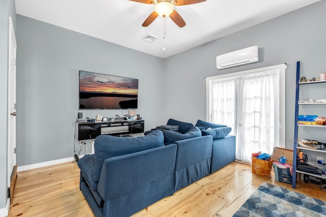 17 Applehead Way, Orrington, ME 04474 - living room featuring a wall unit AC, ceiling fan, and hardwood / wood-style floors