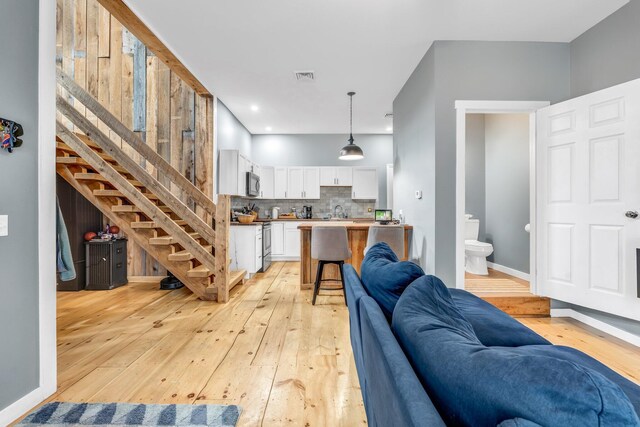 17 Applehead Way, Orrington, ME 04474 - living area featuring light wood-type flooring and stairs