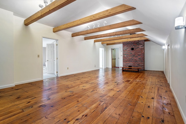 unfurnished living room with hardwood / wood-style floors and beamed ceiling