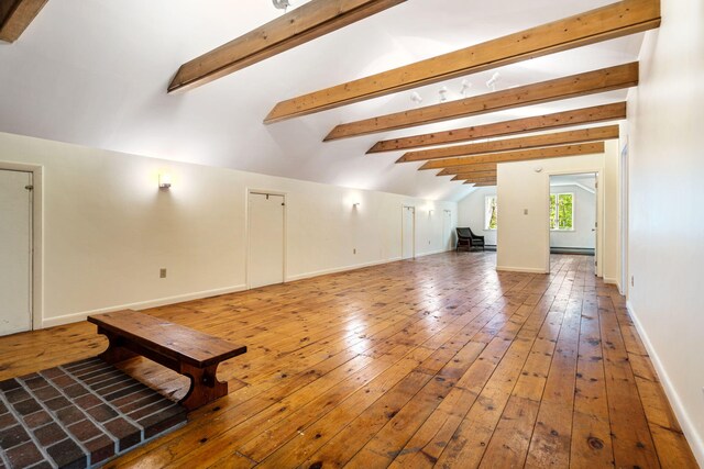 unfurnished living room with wood-type flooring and baseboard heating