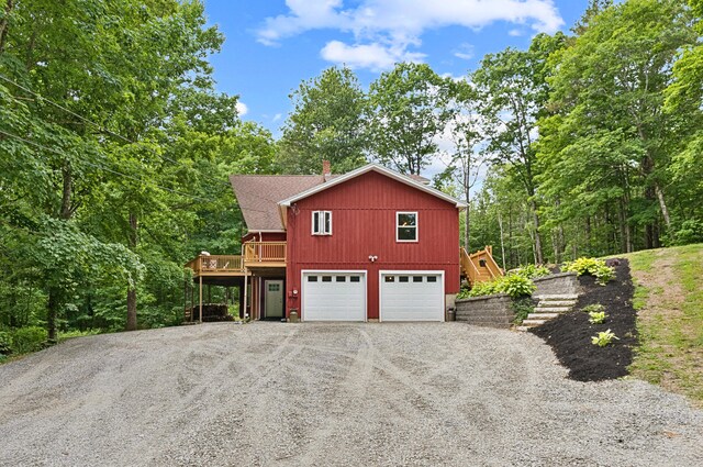 2288 W River Rd, Sidney, ME 04330 - view of side of property with driveway, a chimney, a garage, stairs, and a deck